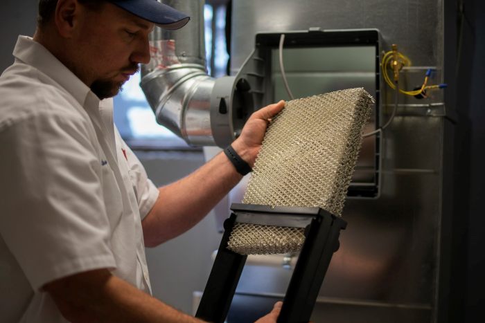 Technician Servicing A Humidifier 